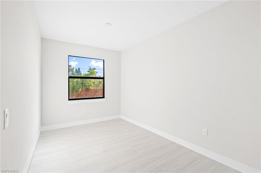 2064 55th Terrace Southwest Naples, FL 34116 - Photo 9 of 30 Empty room with baseboards