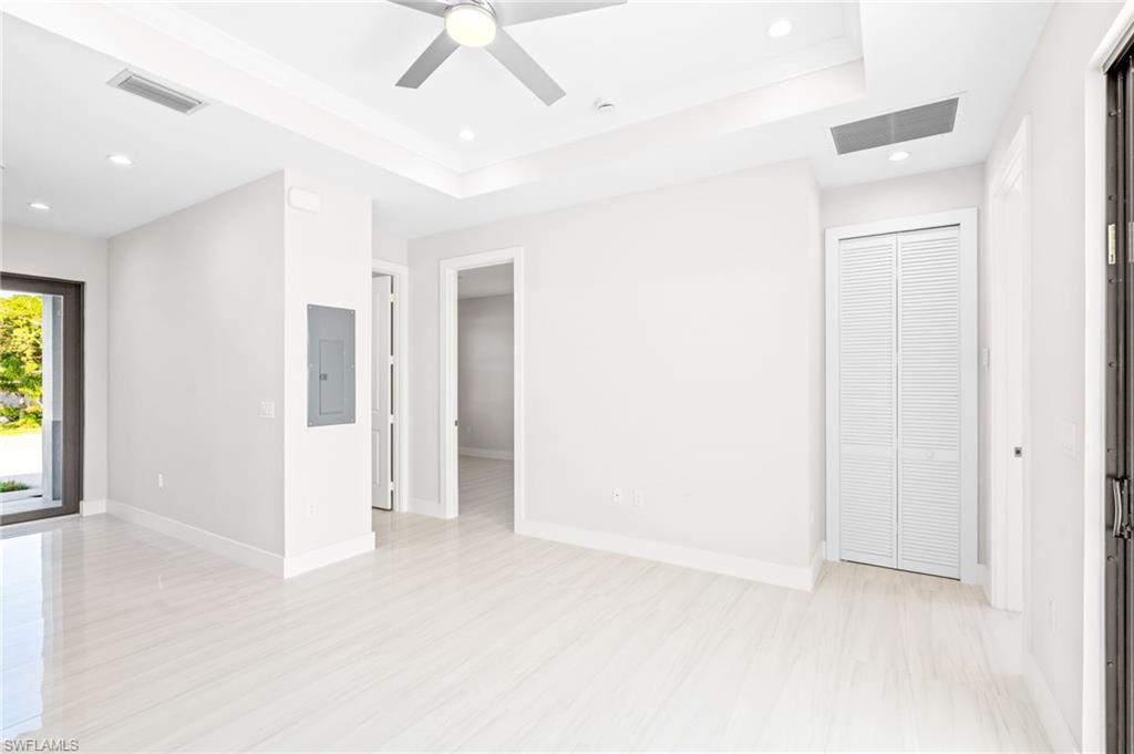 2064 55th Terrace Southwest Naples, FL 34116 - Photo 10 of 30 Spare room with recessed lighting, a tray ceiling, electric panel, and ceiling fan