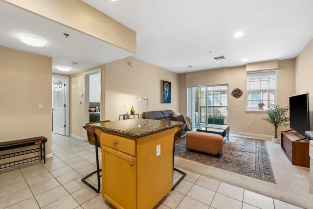 a kitchen with granite countertop counter top space a sink stainless steel appliances and cabinets