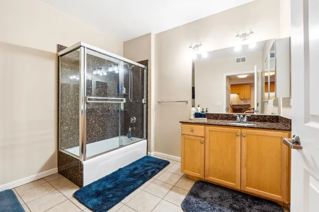 a bathroom with a sink a mirror and a shower