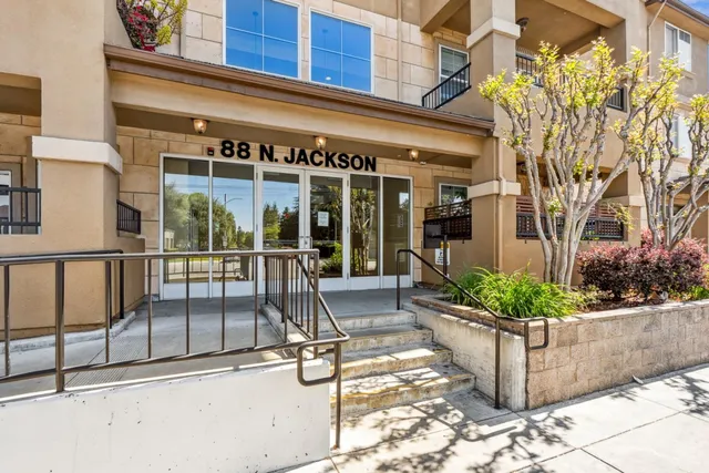 a view of a building with sitting area and furniture