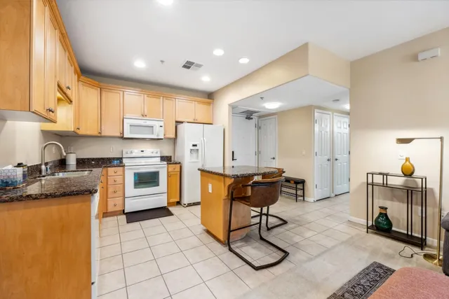 a kitchen with a sink a counter top space and appliances