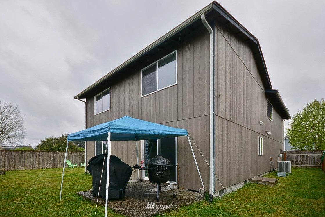 6502 197th Court Southwest Rochester, WA 98579 - Photo 28 of 29 a backyard of a house with table and chairs