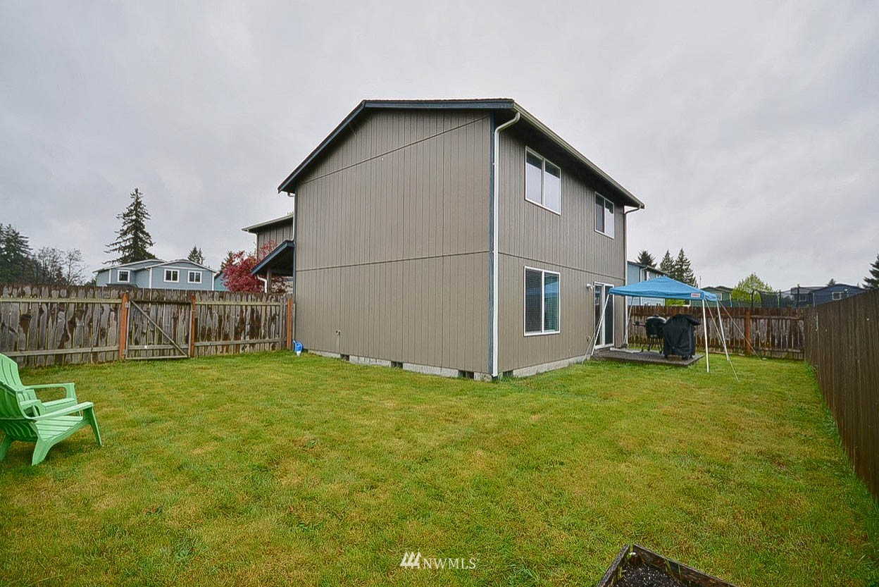 6502 197th Court Southwest Rochester, WA 98579 - Photo 29 of 29 a view of a house with backyard and sitting area