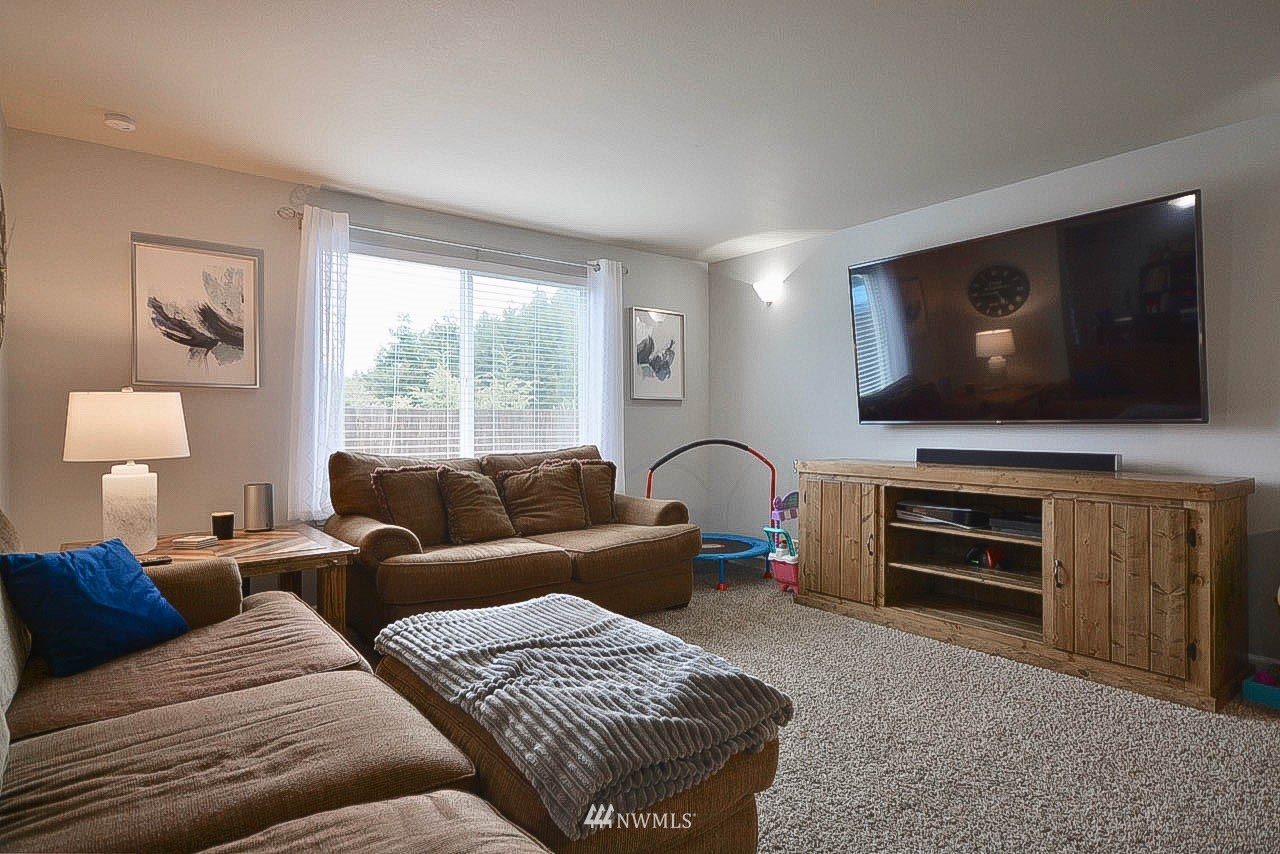 6502 197th Court Southwest Rochester, WA 98579 - Photo 6 of 29 a living room with furniture and a flat screen tv