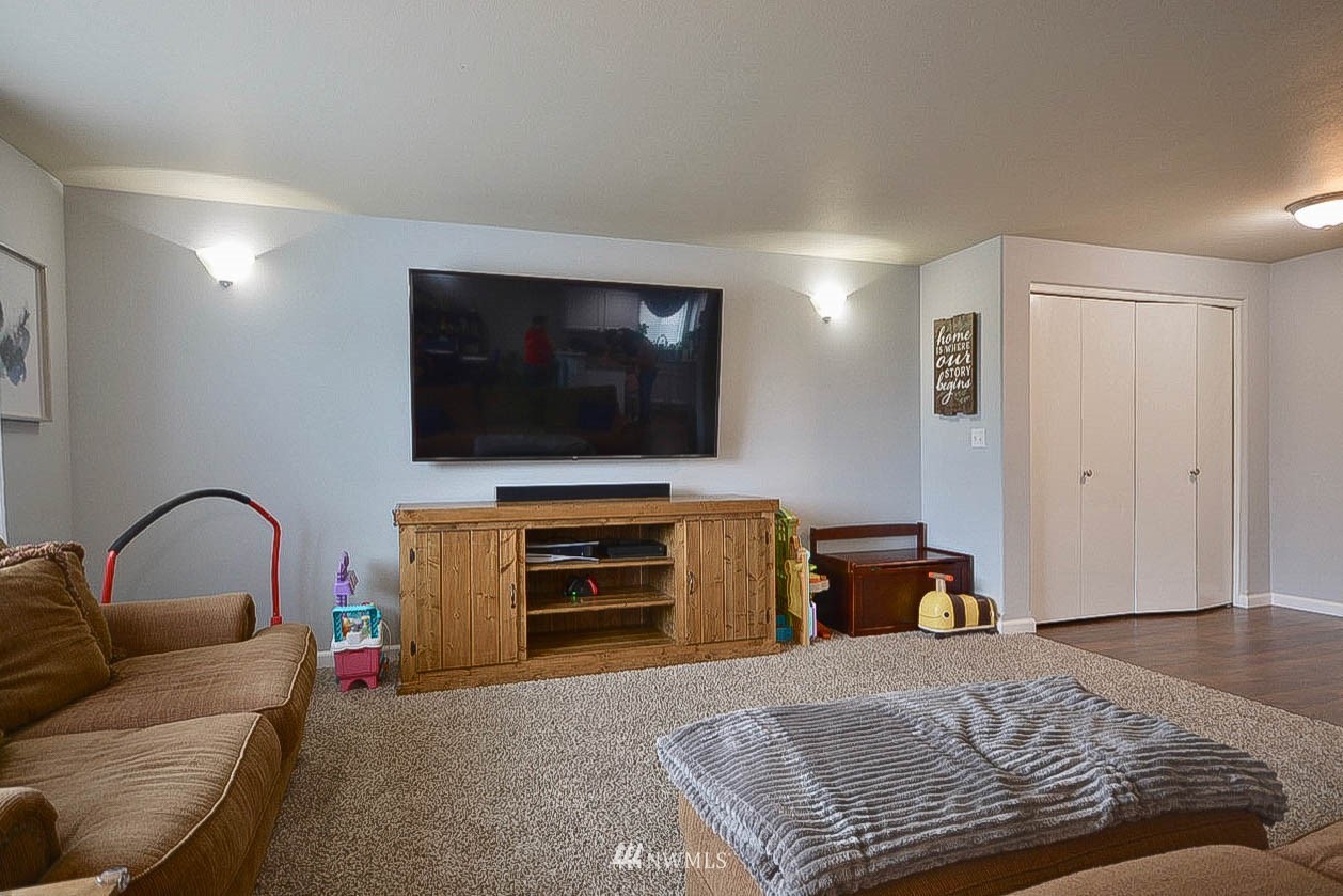 6502 197th Court Southwest Rochester, WA 98579 - Photo 7 of 29 a bedroom with a bed and a flat screen tv