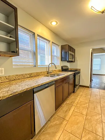 a kitchen with stainless steel appliances granite countertop a sink and cabinets