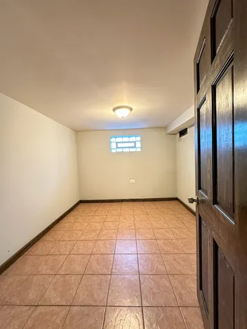 a view of a livingroom with a large window and potted plant