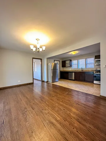a view of a living room with kitchen and a sink