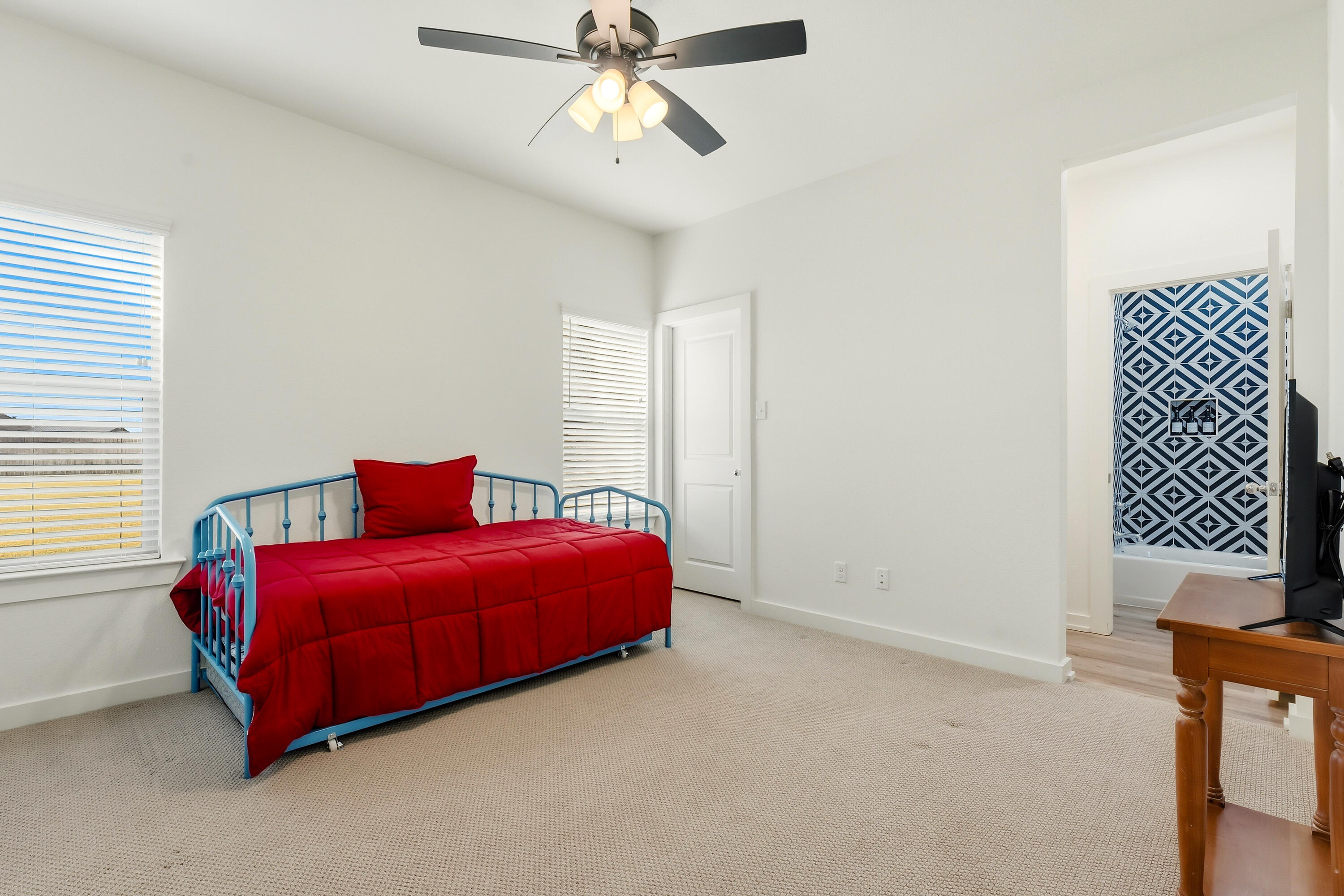 3613 County Road 7660 Lubbock, TX 79423 - Photo 24 of 41 a bedroom with a bed and a chandelier