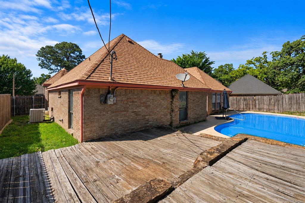 3506 Ruidoso Drive Arlington, TX 76017 - Photo 37 of 37 Backyard featuring an in-ground pool, a multi-level wood deck, a brick exterior, and a privacy fence