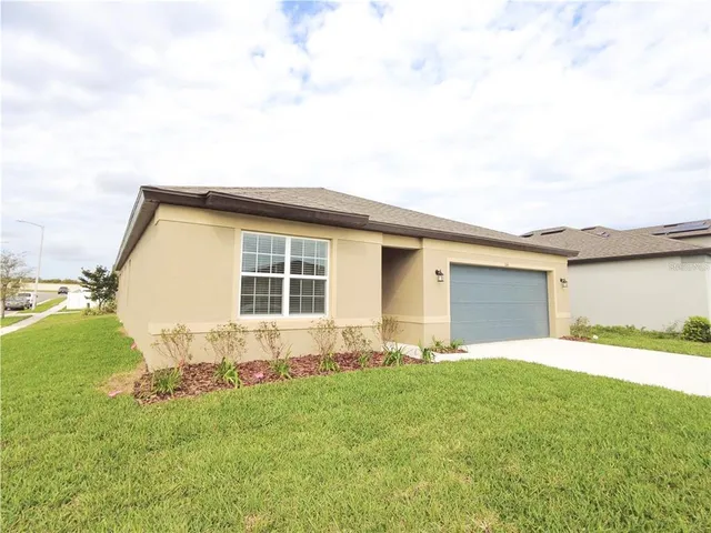 a front view of house with yard and outdoor seating