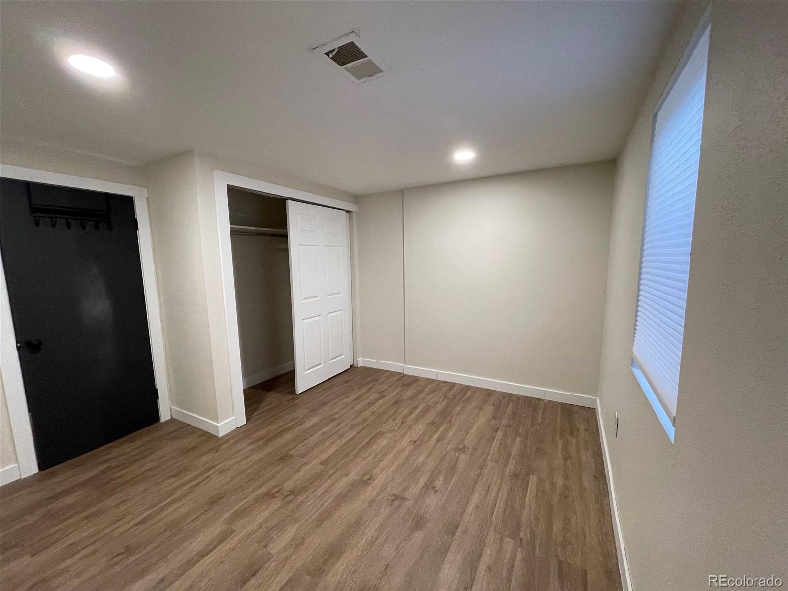7770 South Kit Carson Drive Centennial, CO 80122 - Photo 15 of 30 an empty room with wooden floor and closet