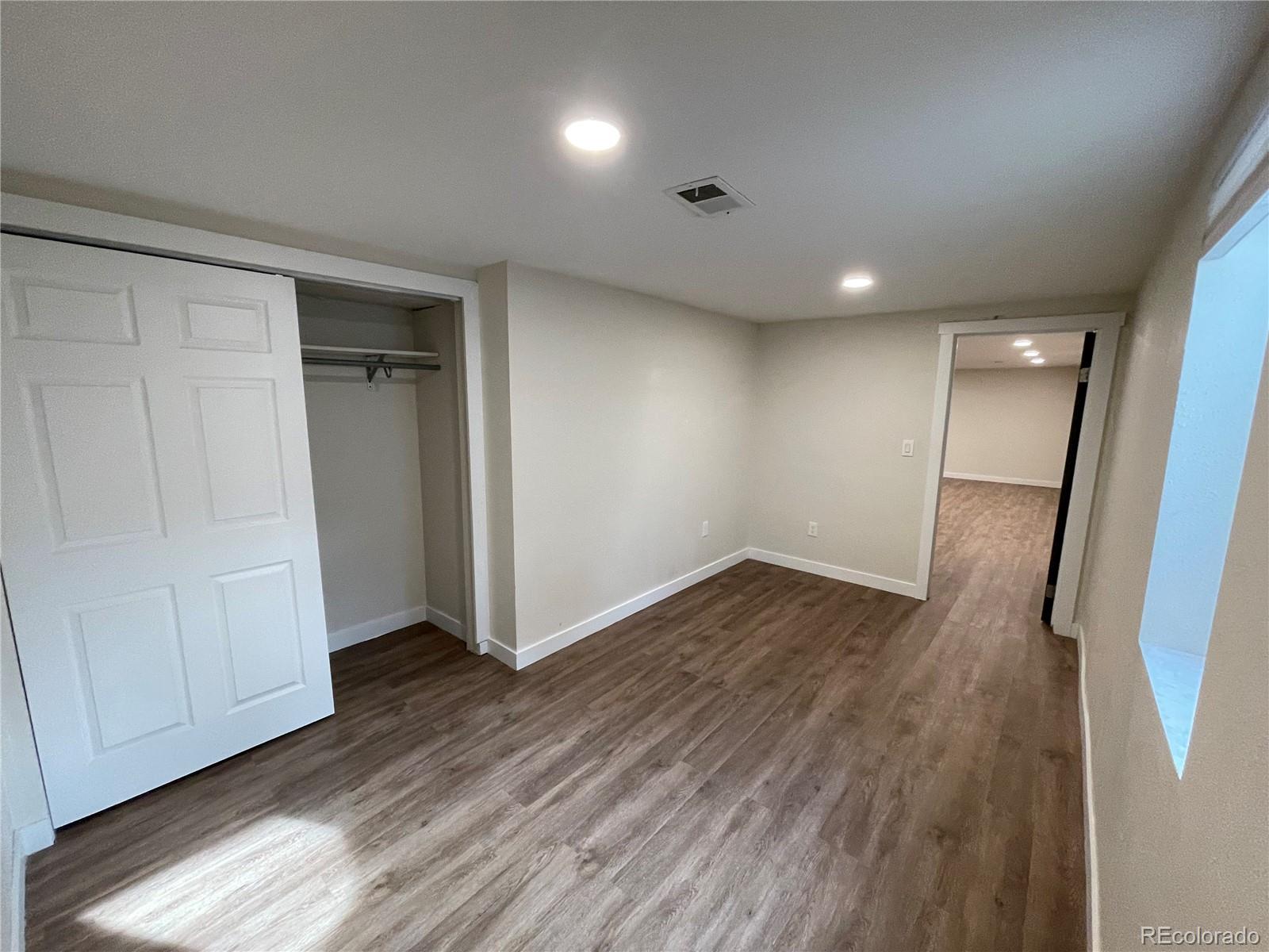 7770 South Kit Carson Drive Centennial, CO 80122 - Photo 16 of 30 wooden floor in an empty room with a window