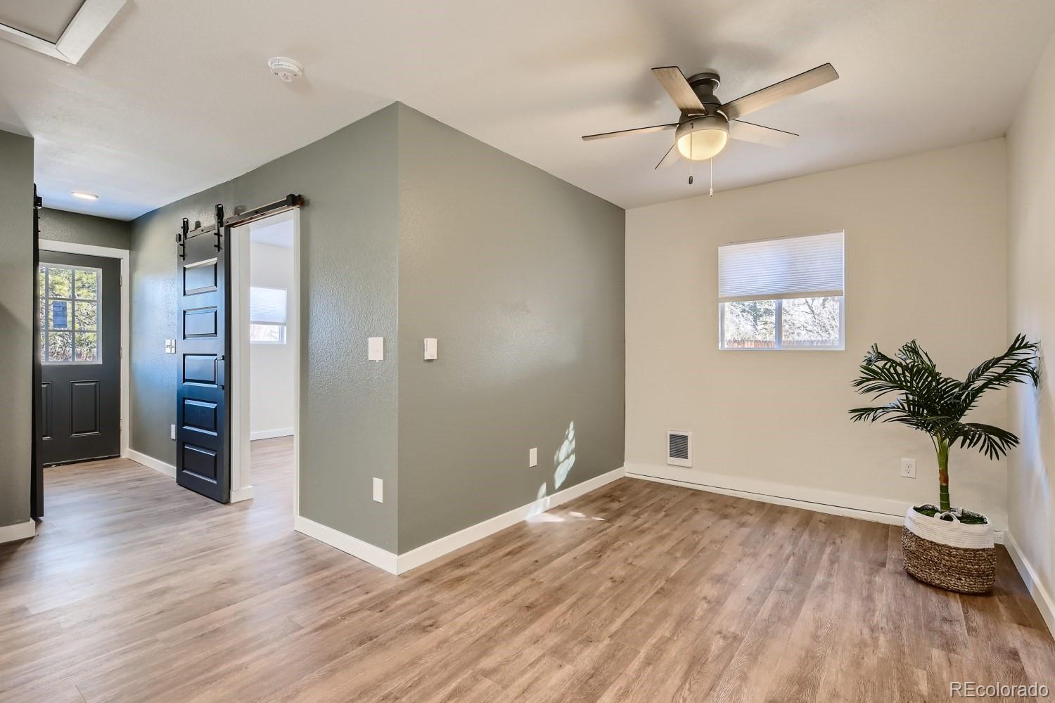7770 South Kit Carson Drive Centennial, CO 80122 - Photo 22 of 30 a view of an empty room with window and wooden floor