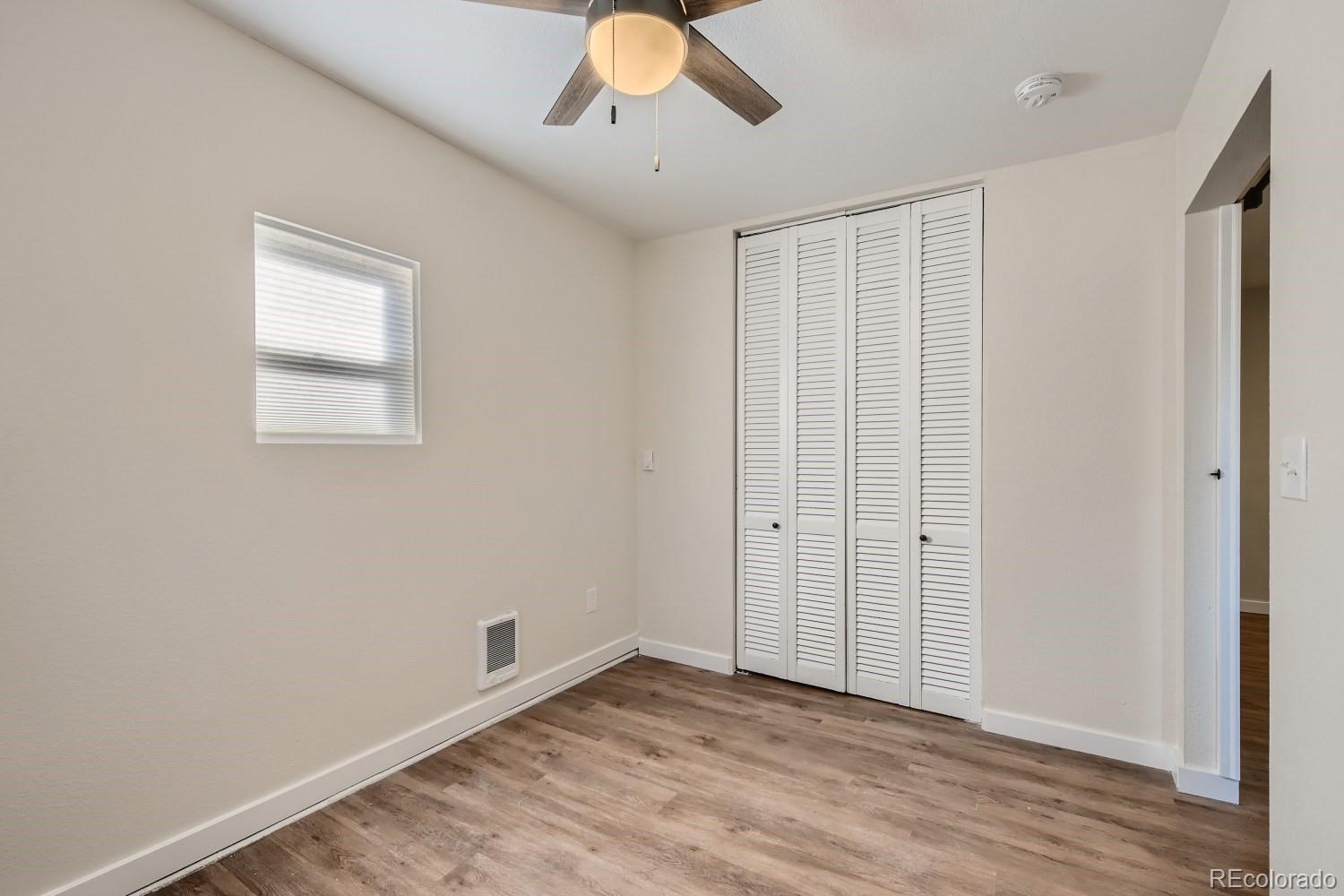 7770 South Kit Carson Drive Centennial, CO 80122 - Photo 24 of 30 a view of an empty room with wooden floor and a window