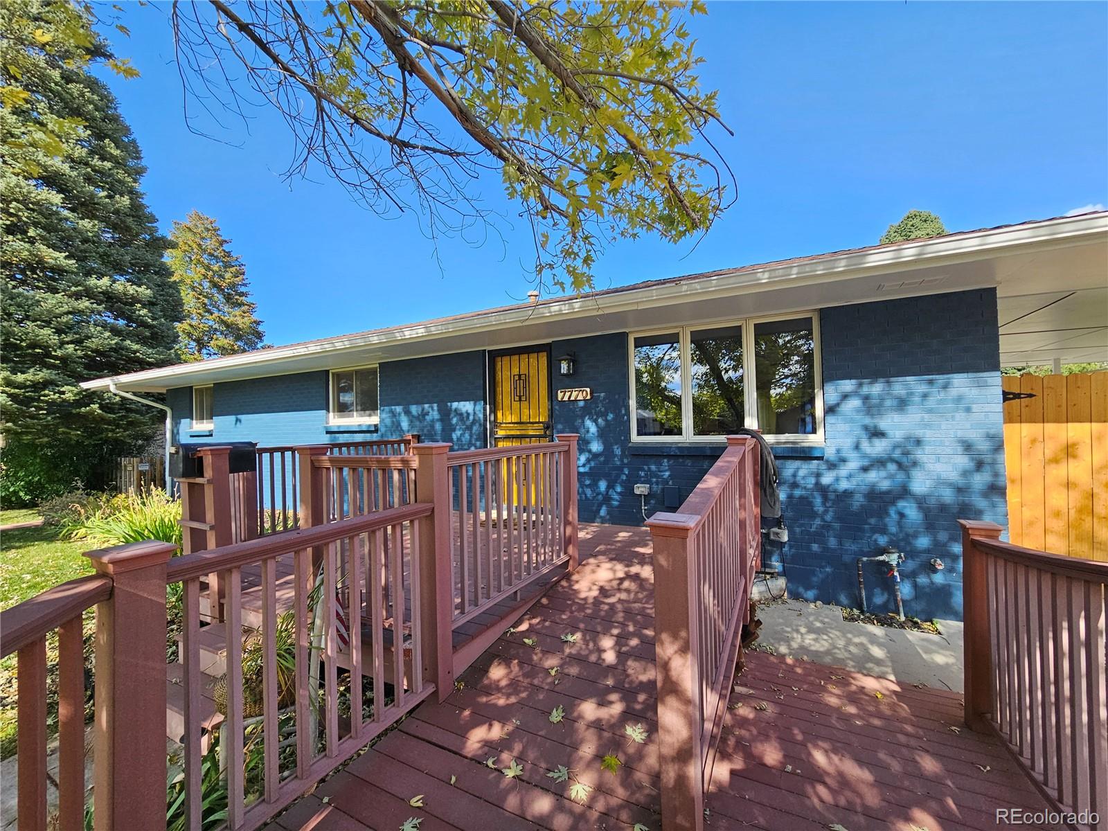 7770 South Kit Carson Drive Centennial, CO 80122 - Photo 4 of 30 a view of a house with backyard and deck