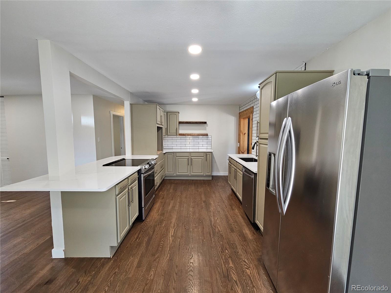 7770 South Kit Carson Drive Centennial, CO 80122 - Photo 5 of 30 a kitchen with stainless steel appliances a refrigerator and a stove