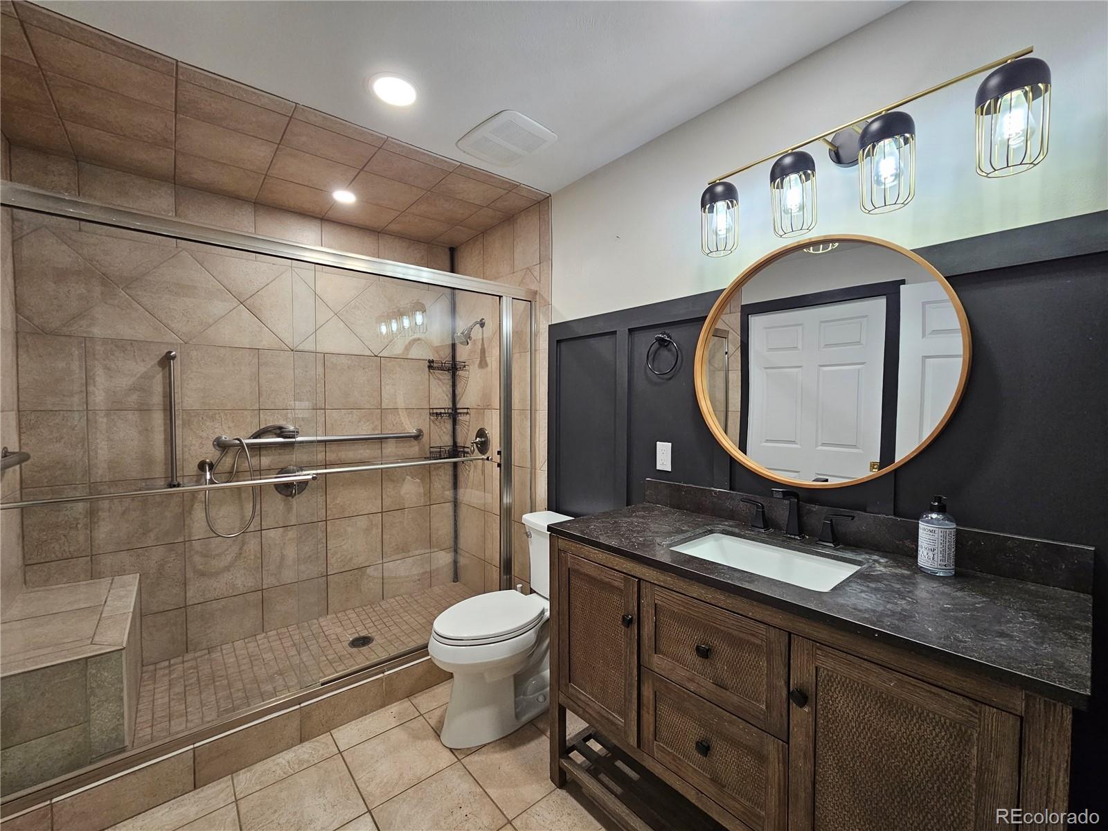 7770 South Kit Carson Drive Centennial, CO 80122 - Photo 8 of 30 a bathroom with a toilet a sink and mirror