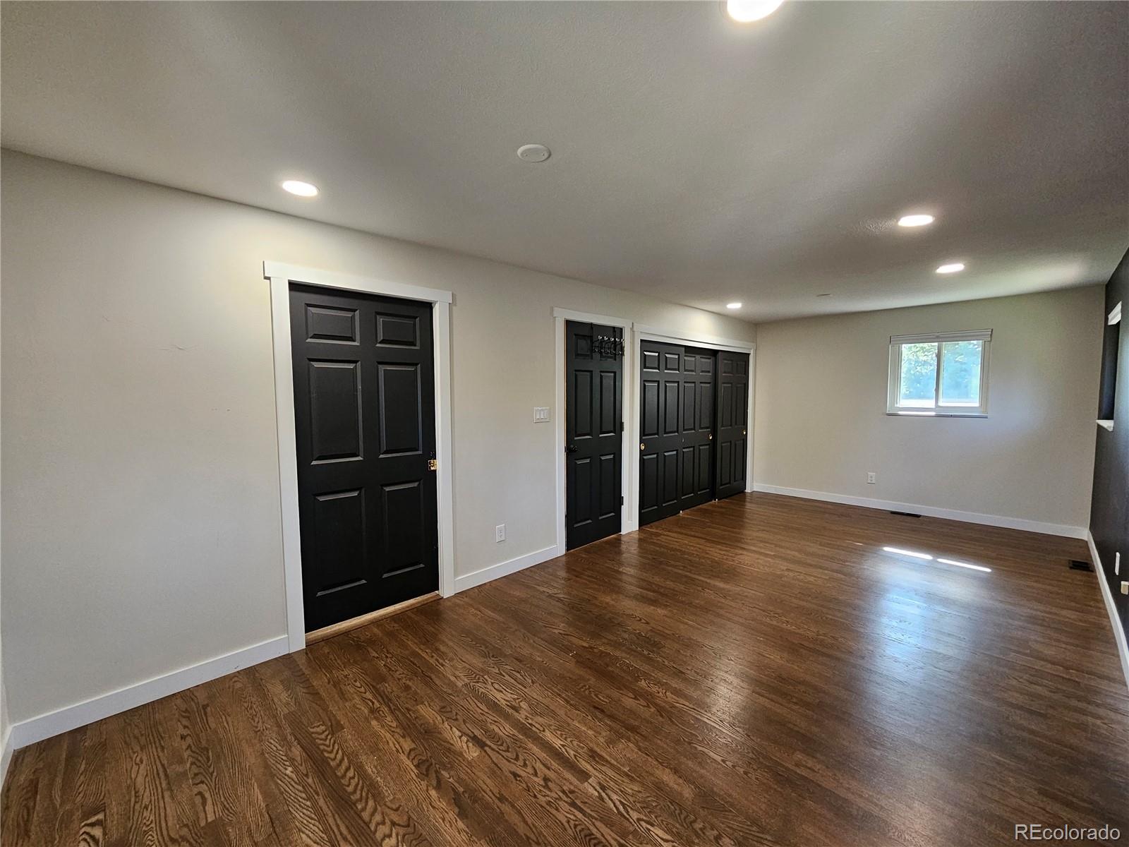 7770 South Kit Carson Drive Centennial, CO 80122 - Photo 9 of 30 a view of an empty room with wooden floor and a window