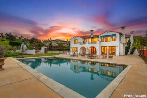 an aerial view of a house with a swimming pool