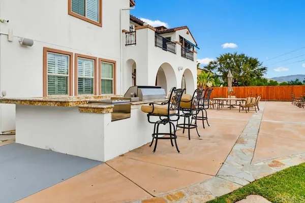 a view of a patio with table and chairs