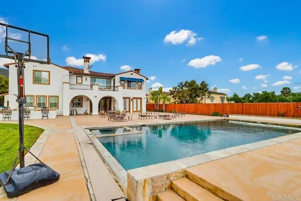 a view of a swimming pool with a house
