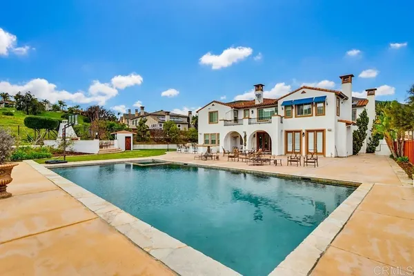 an aerial view of a house with a swimming pool