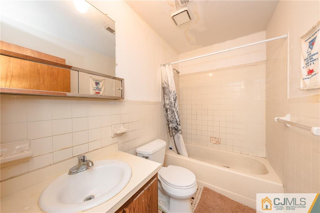 1915 Raspberry Court, Unit 1915 Edison, NJ 08817 - Photo 12 of 18 a bathroom with a sink a toilet and shower
