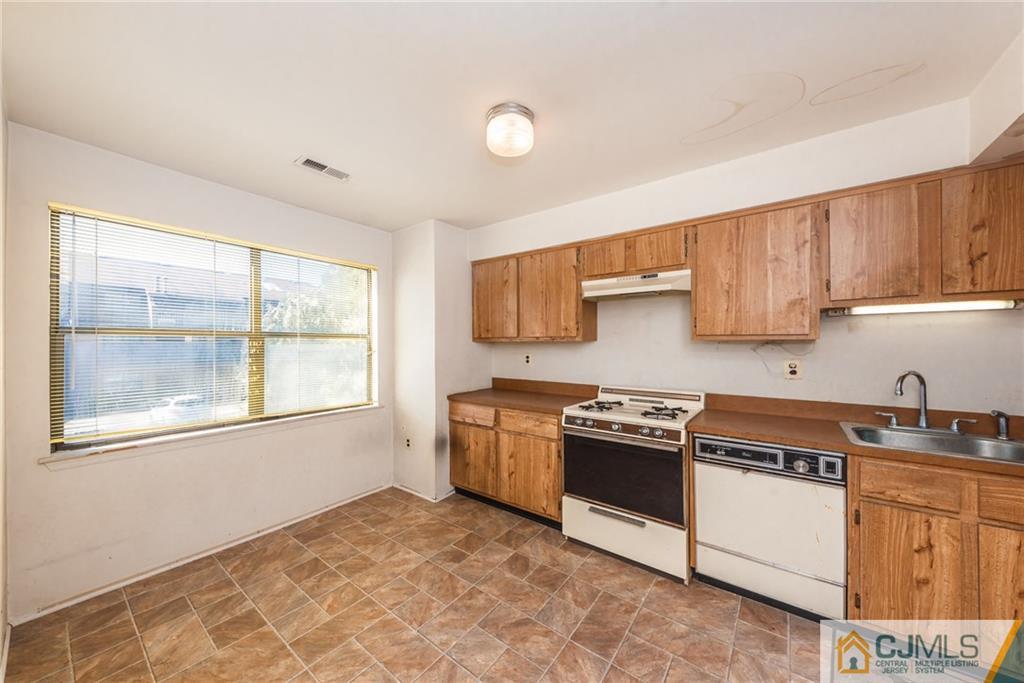 1915 Raspberry Court, Unit 1915 Edison, NJ 08817 - Photo 13 of 18 a kitchen with granite countertop a stove a sink and a granite counter tops