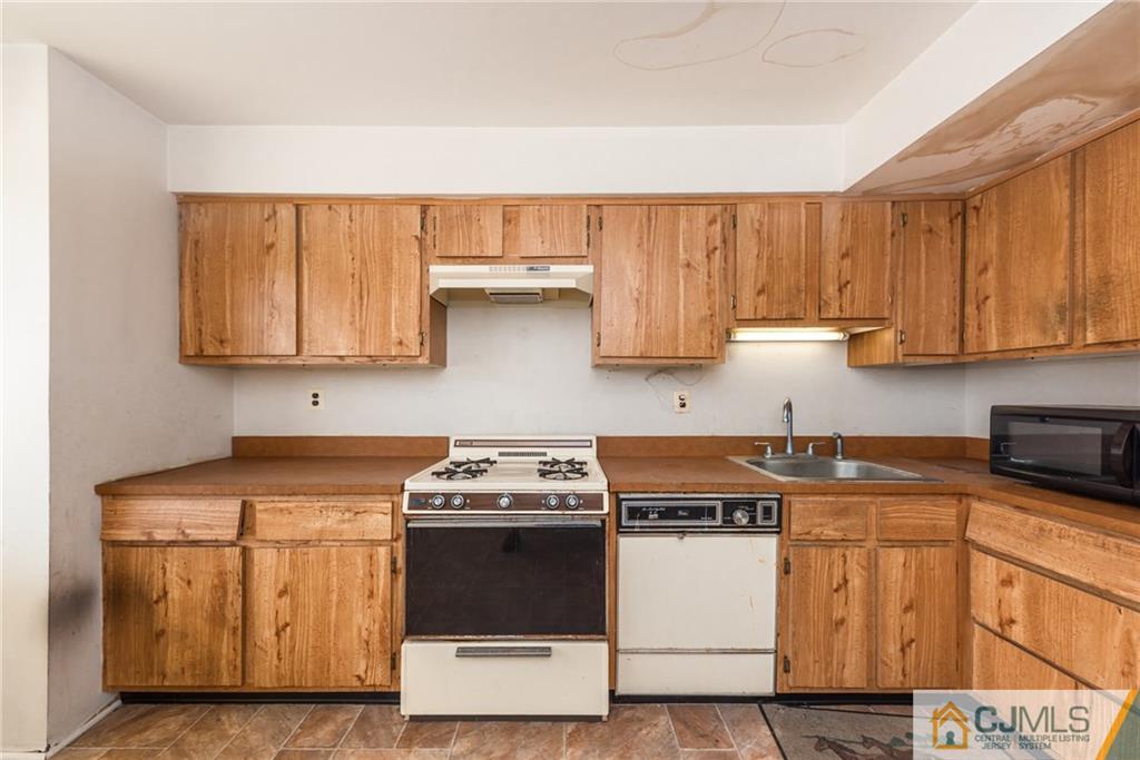 1915 Raspberry Court, Unit 1915 Edison, NJ 08817 - Photo 15 of 18 a kitchen with stainless steel appliances granite countertop a stove a sink and a white cabinets