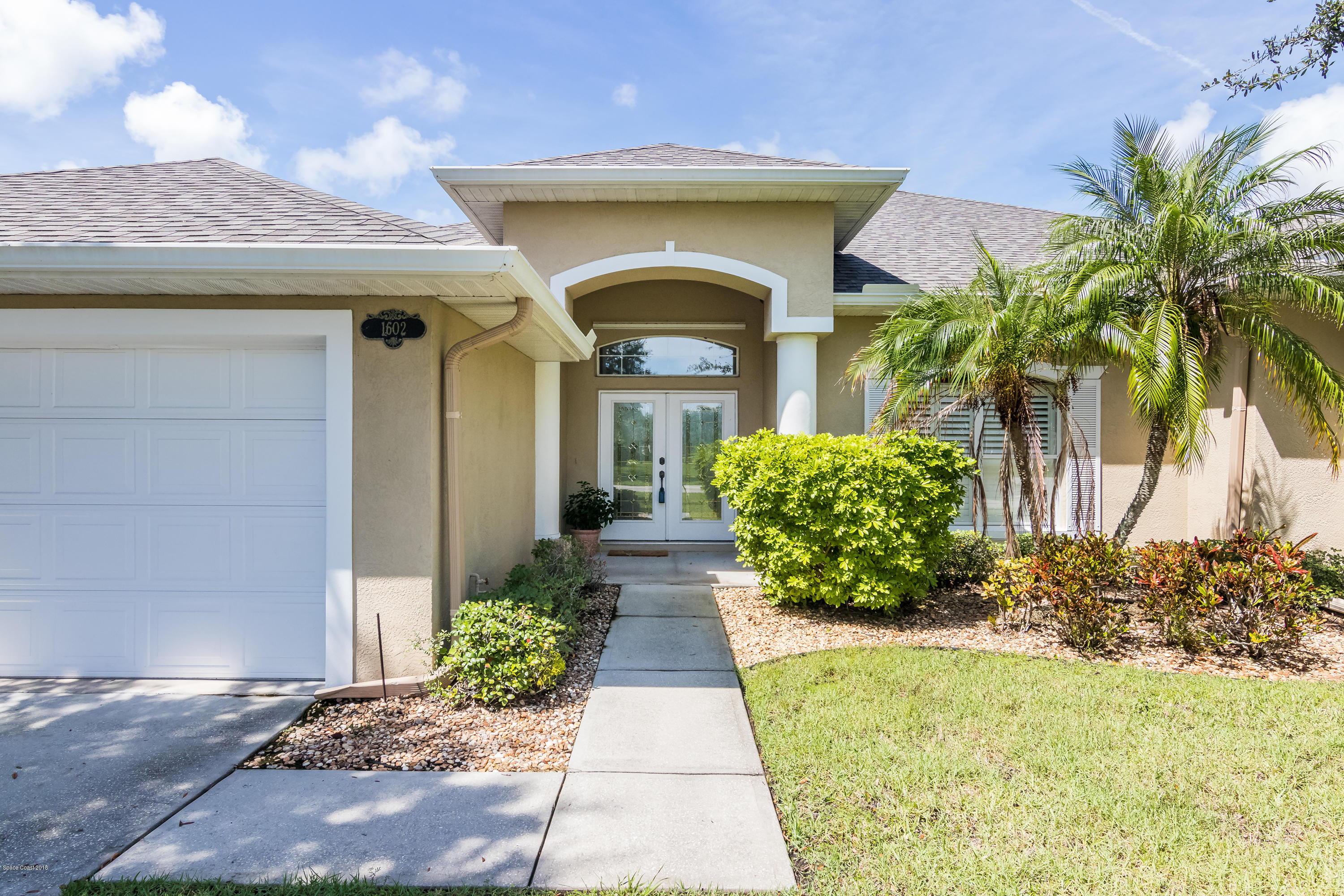 1602 Long Pine Road Melbourne, FL 32940 - Photo 1 of 28 a front view of a house with garden