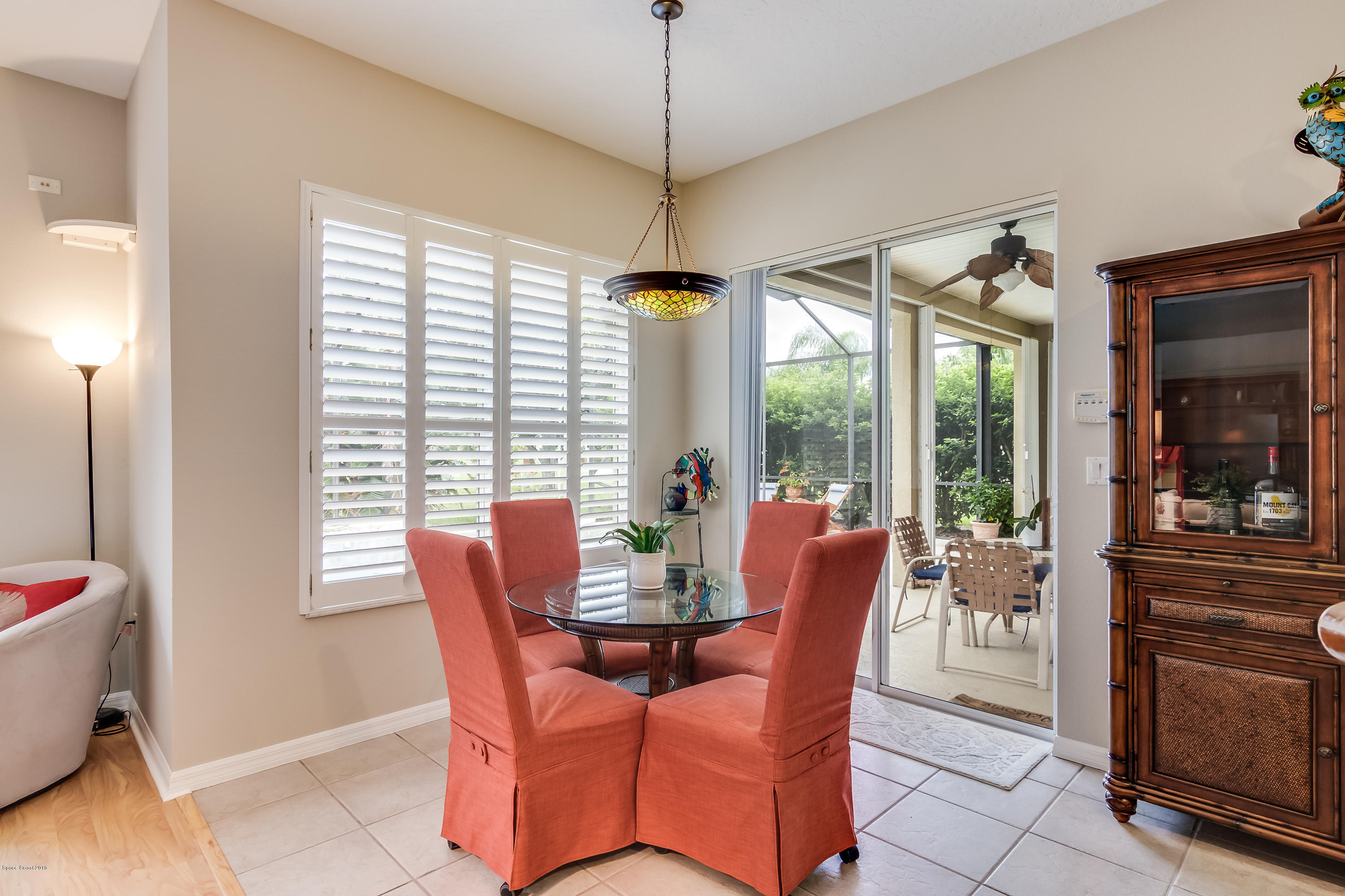 1602 Long Pine Road Melbourne, FL 32940 - Photo 11 of 28 a dining room with furniture large windows and a chandelier