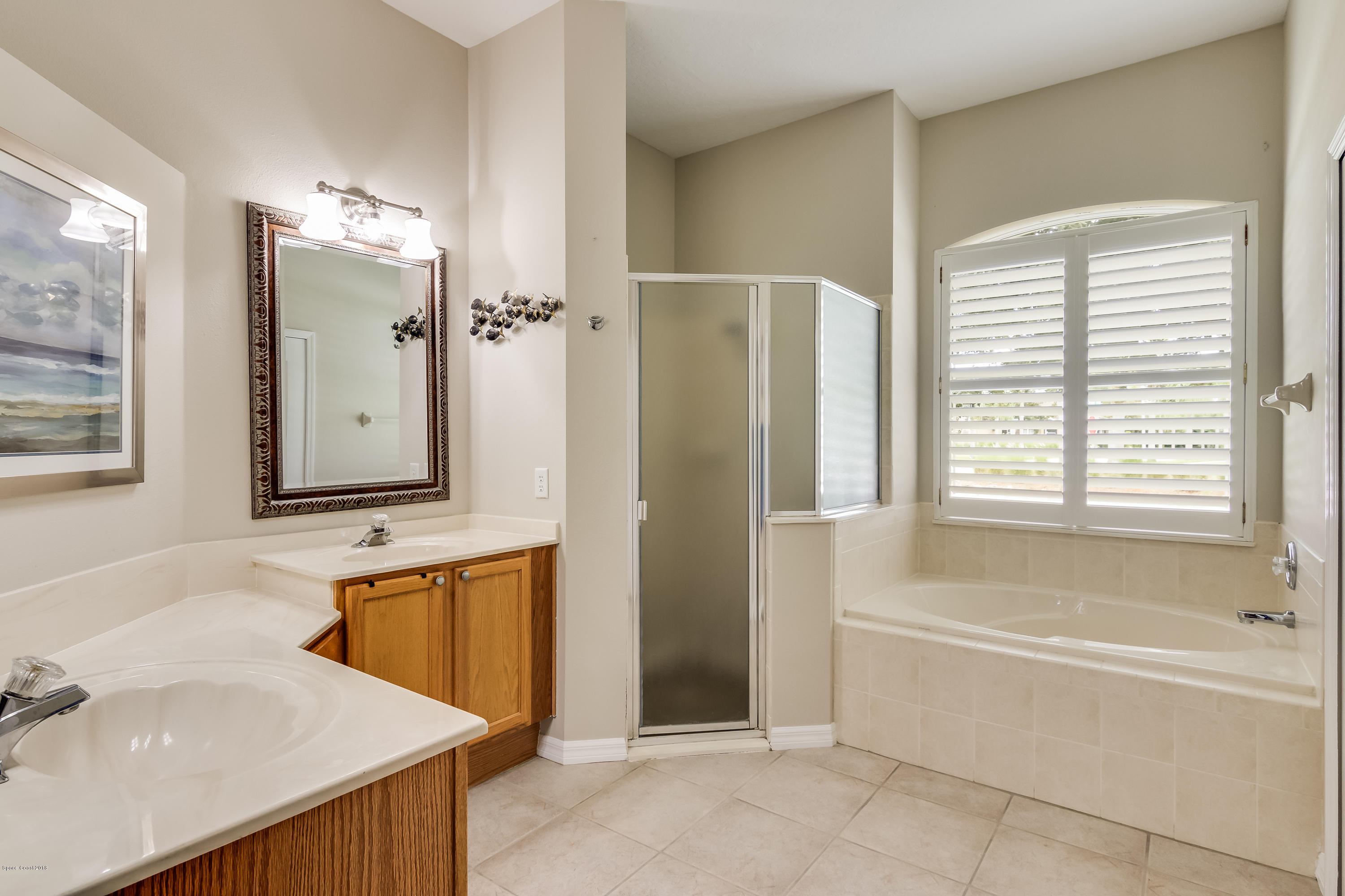 1602 Long Pine Road Melbourne, FL 32940 - Photo 14 of 28 a bathroom with a tub sink and mirror