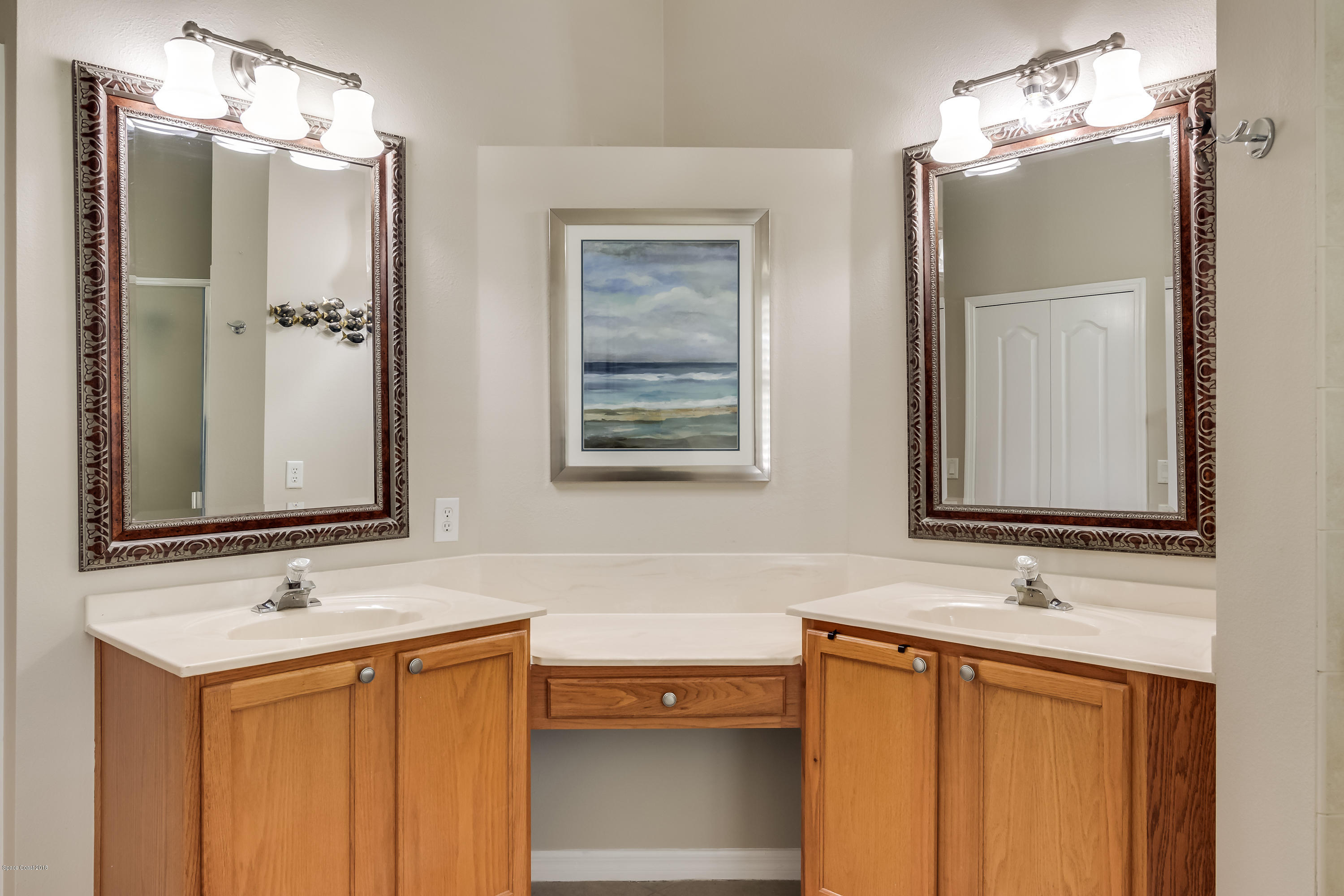 1602 Long Pine Road Melbourne, FL 32940 - Photo 15 of 28 a bathroom with a sink vanity and a mirror