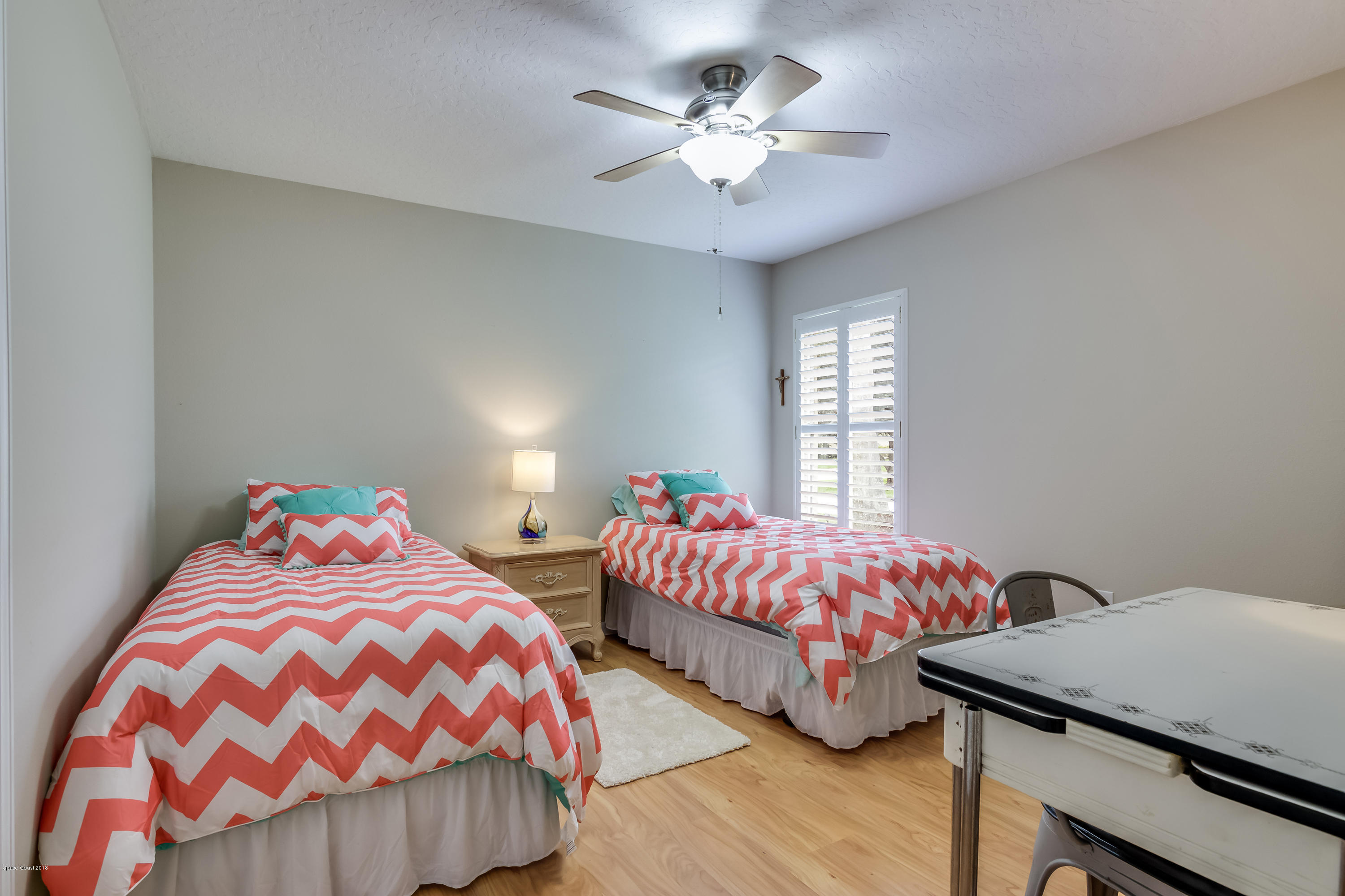 1602 Long Pine Road Melbourne, FL 32940 - Photo 16 of 28 a bedroom with two beds and a chandelier