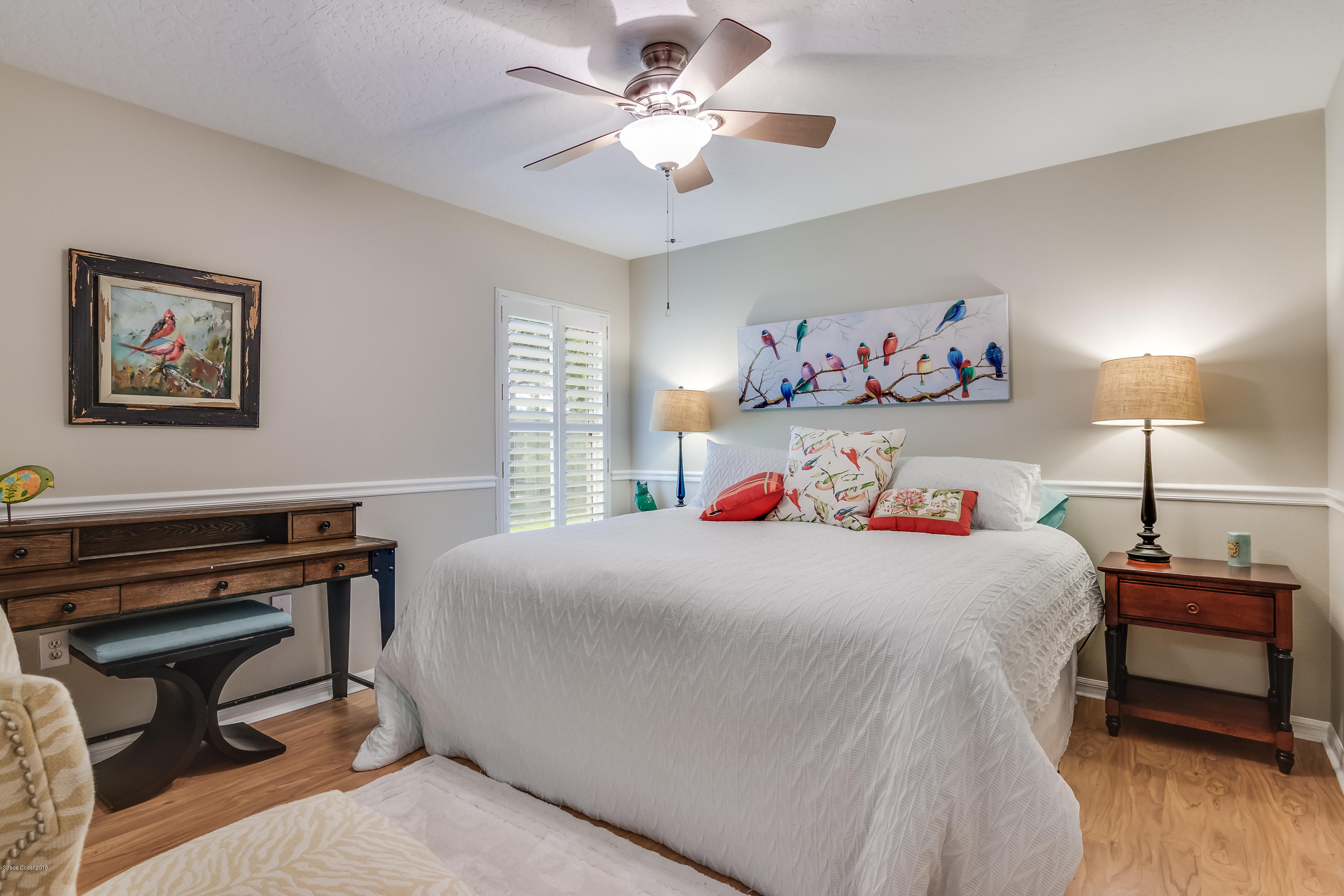 1602 Long Pine Road Melbourne, FL 32940 - Photo 17 of 28 a bedroom with a bed and a chandelier