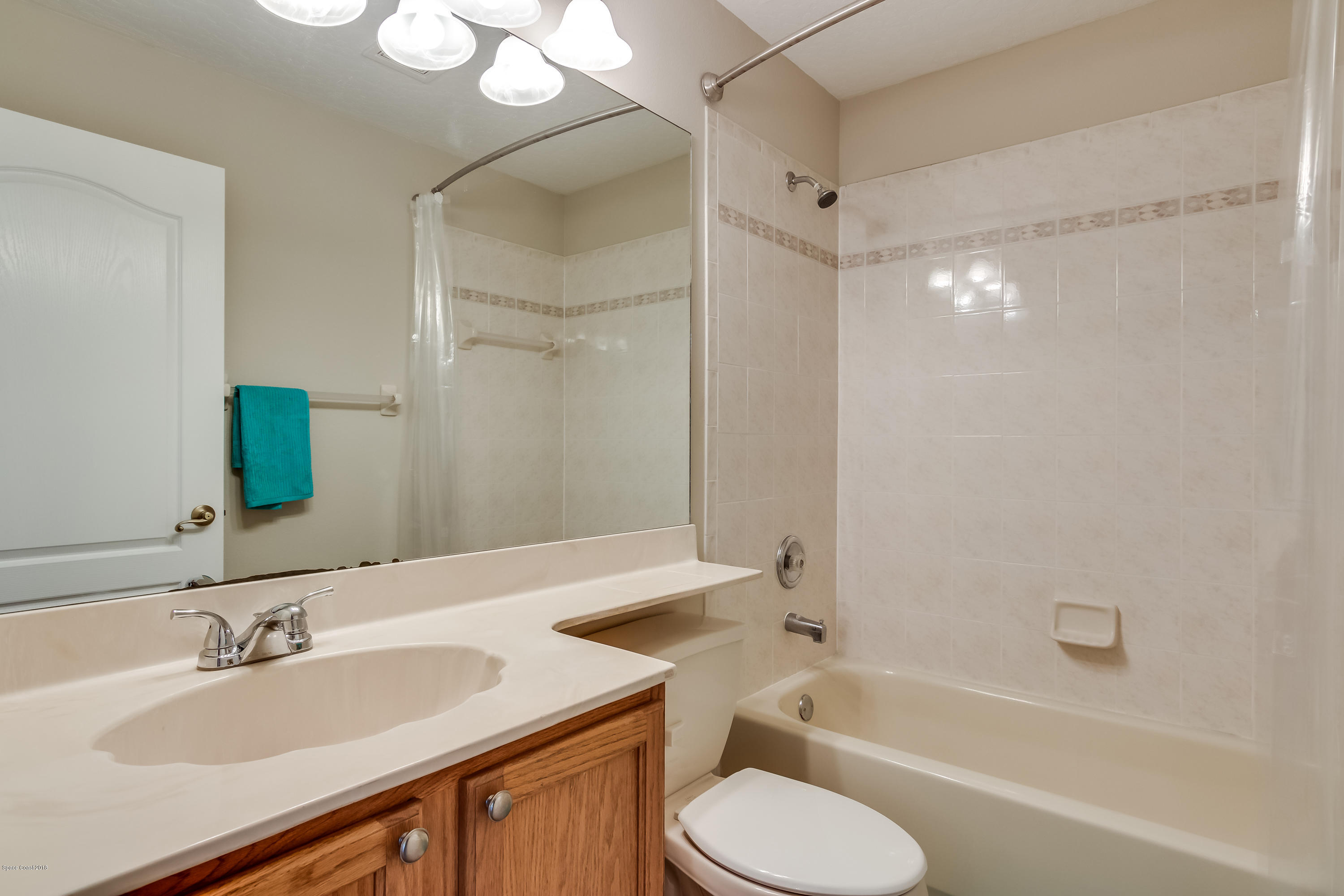 1602 Long Pine Road Melbourne, FL 32940 - Photo 18 of 28 a bathroom with a granite countertop sink toilet and shower