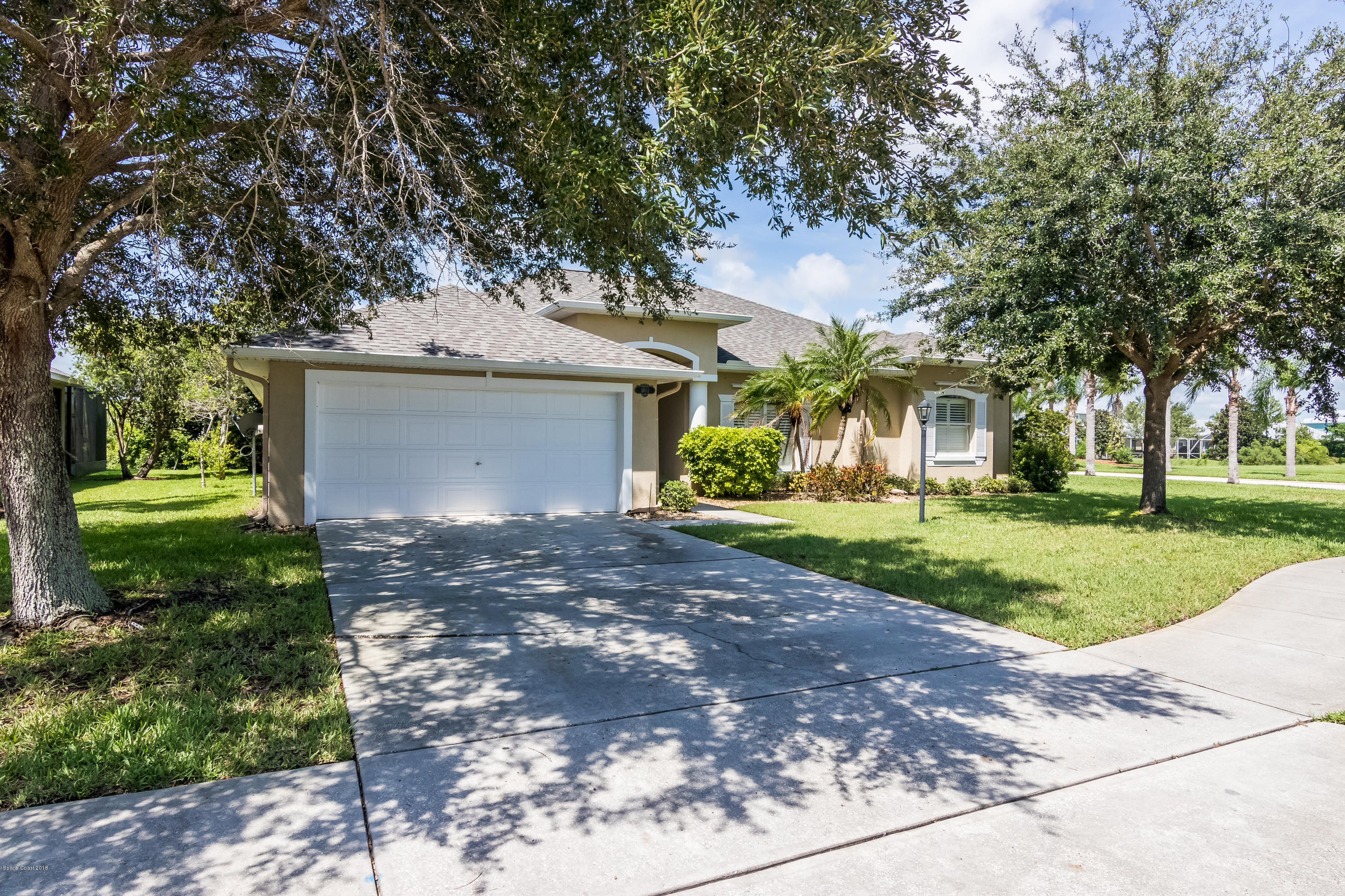 1602 Long Pine Road Melbourne, FL 32940 - Photo 3 of 28 a view of a yard with plants and a large tree