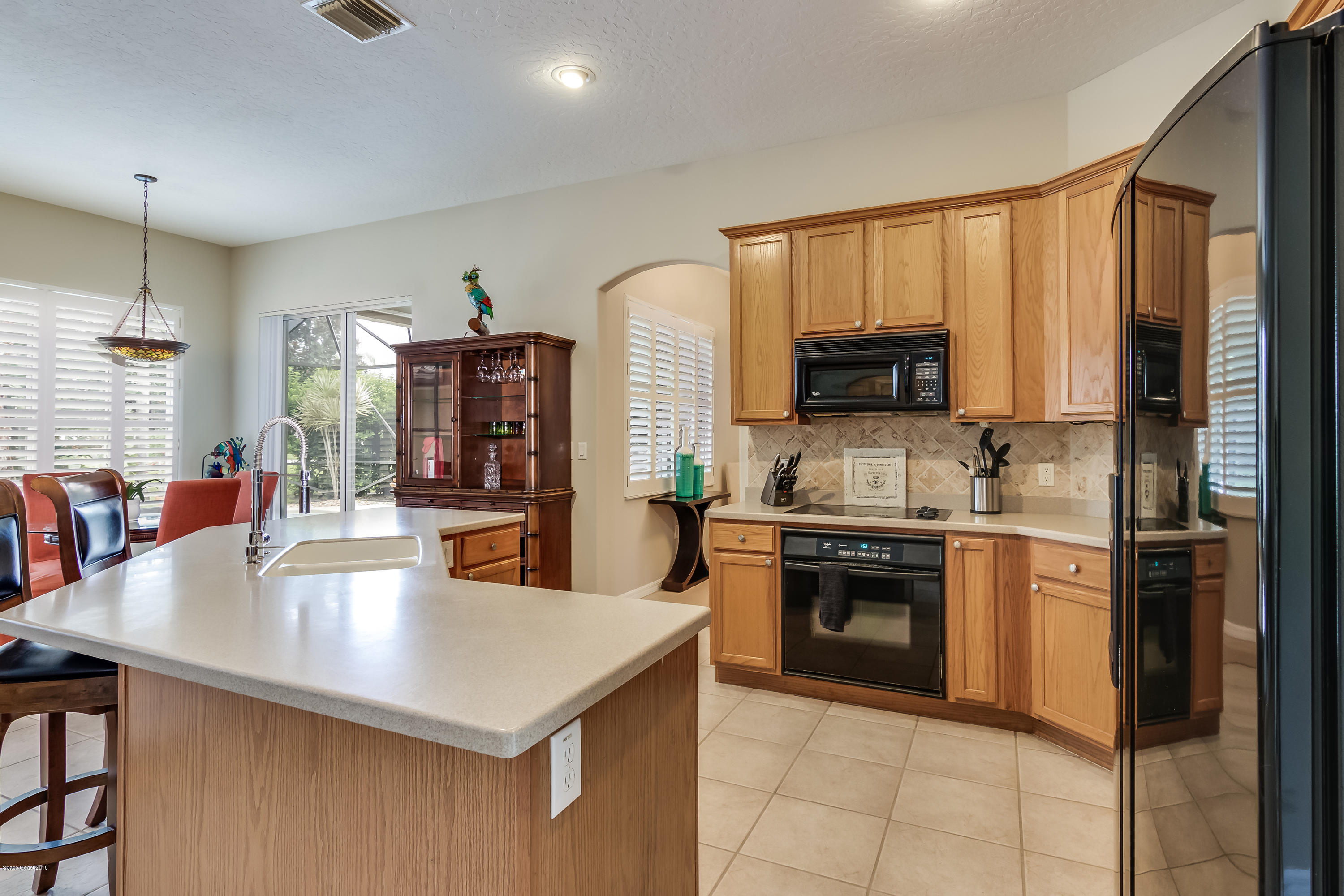 1602 Long Pine Road Melbourne, FL 32940 - Photo 8 of 28 a kitchen with stainless steel appliances granite countertop a stove refrigerator and a sink