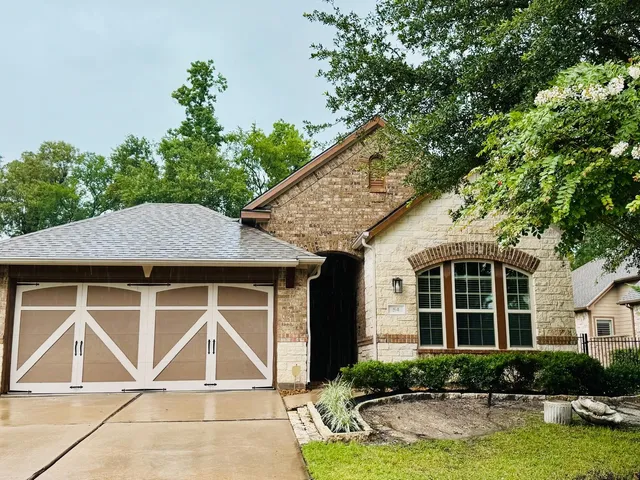 a front view of a house with garden
