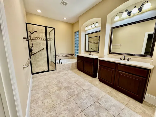 a bathroom with a mirror sink and mirror