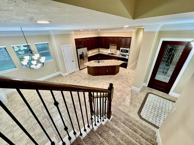 a view of a hallway with wooden floor and furniture