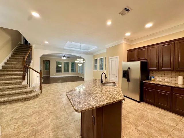 a kitchen with refrigerator sink and cabinets
