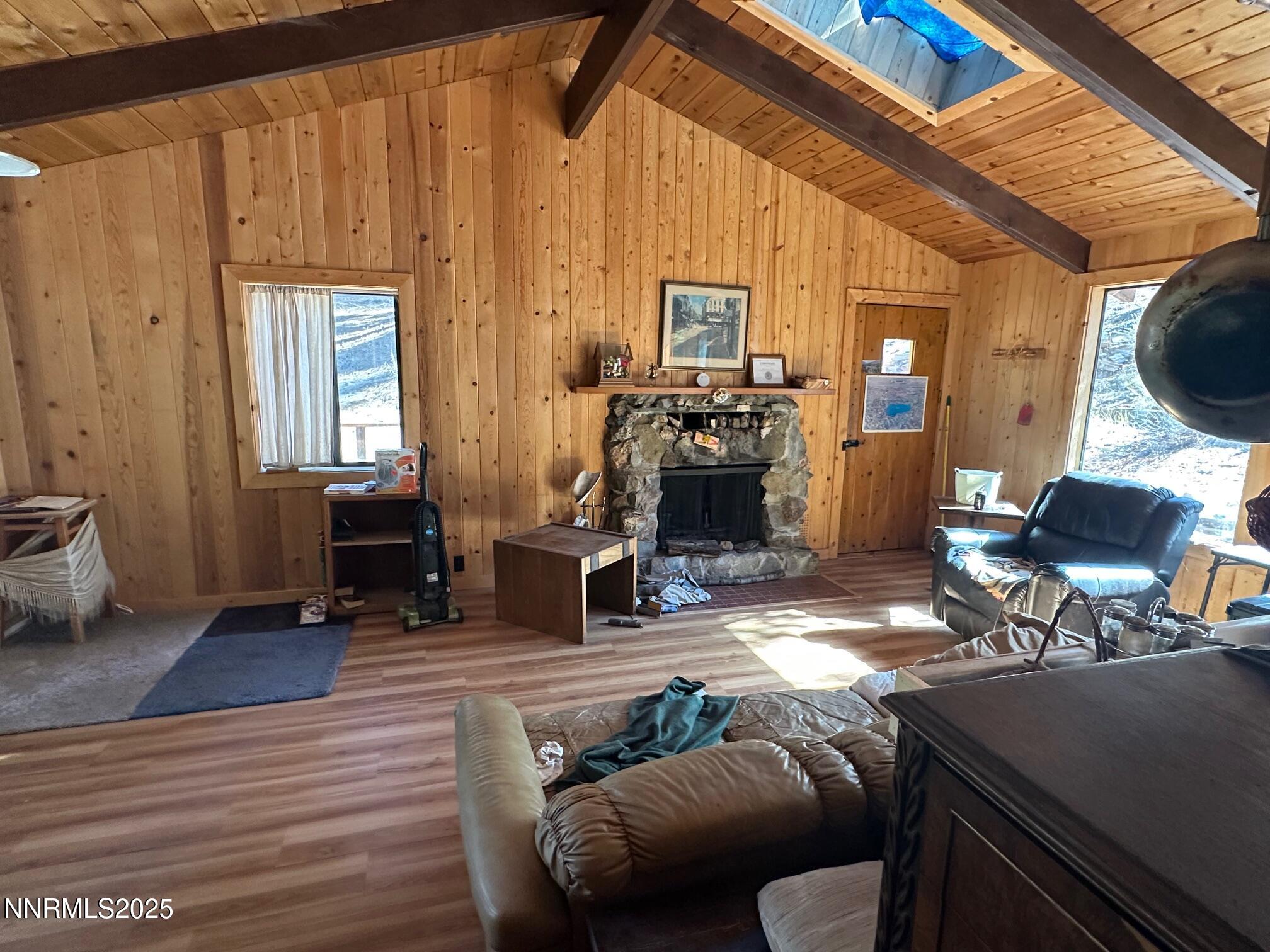 201 Shay Creek Road Markleeville, CA 96120 - Photo 14 of 35 a living room with furniture a fireplace and a table