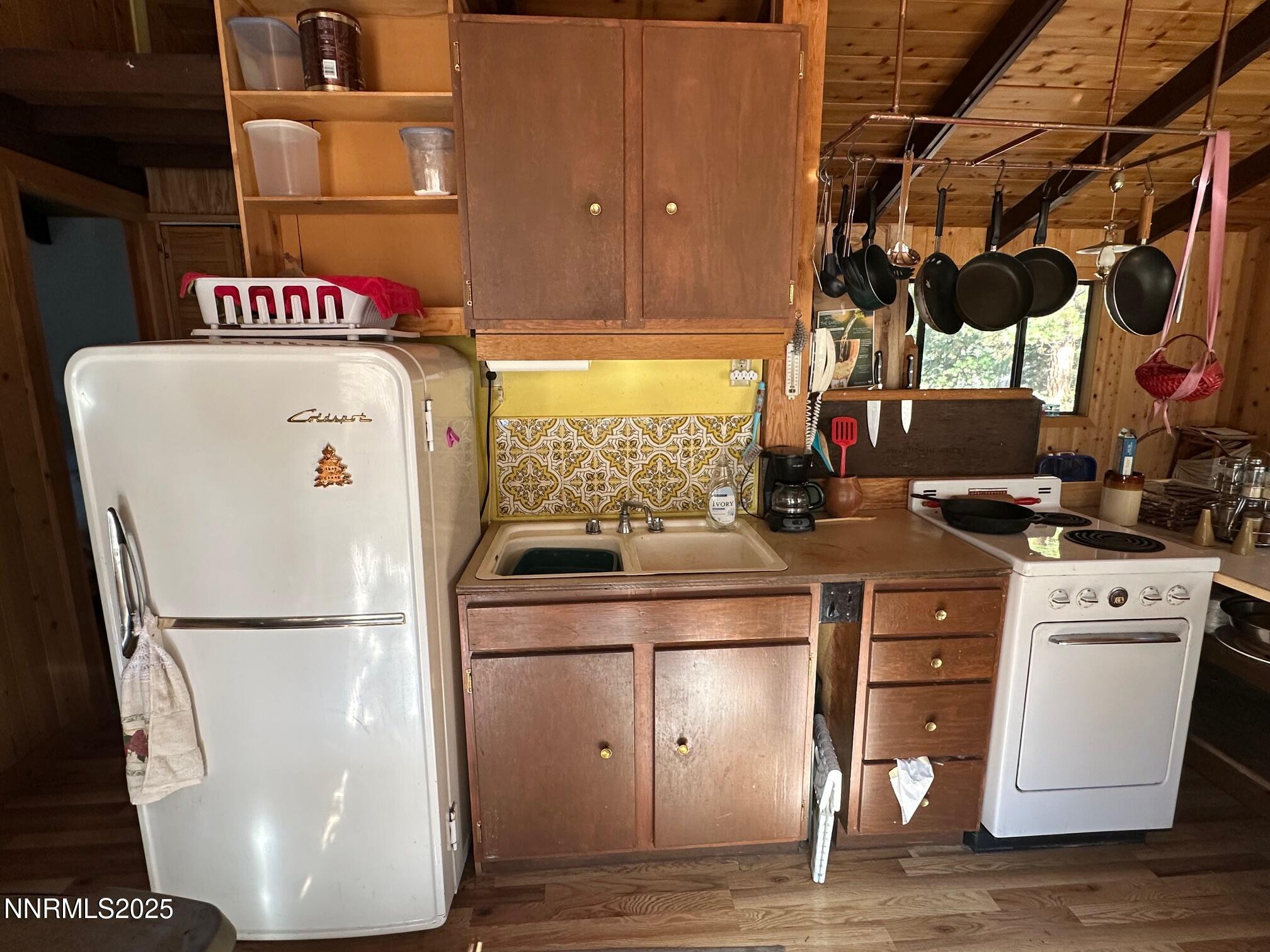 201 Shay Creek Road Markleeville, CA 96120 - Photo 18 of 35 a utility room with a refrigerator and window