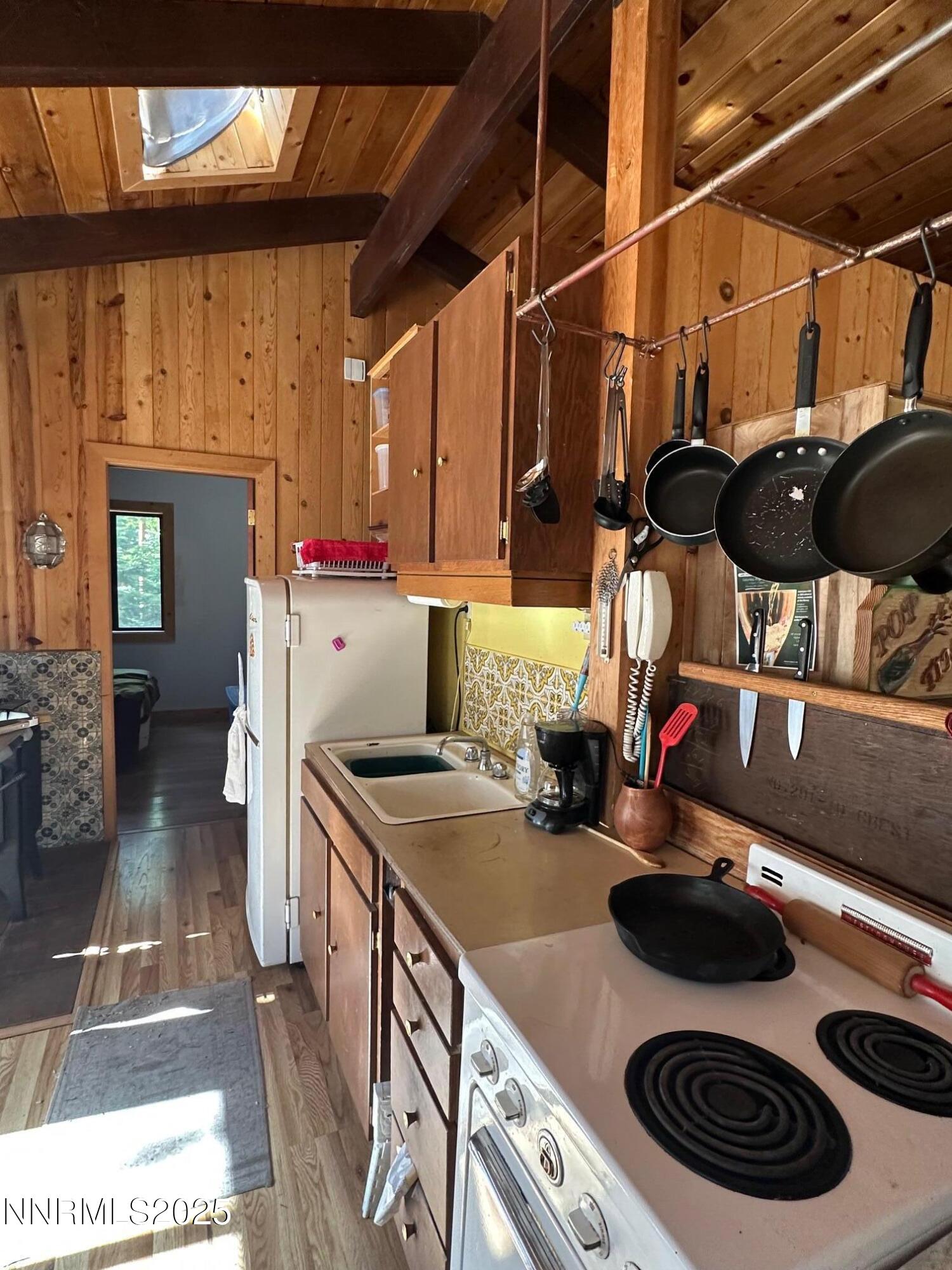 201 Shay Creek Road Markleeville, CA 96120 - Photo 22 of 35 a kitchen with a stove and a wooden floor