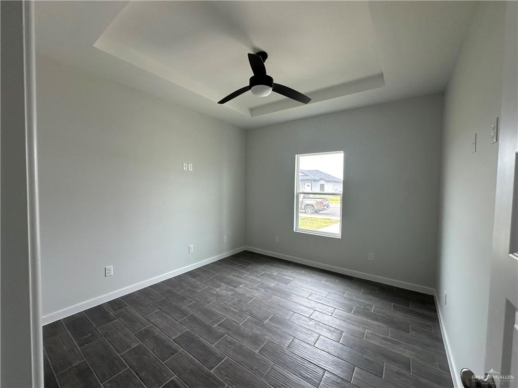 1704 Unity Drive Mercedes, TX 78570 - Photo 6 of 11 an empty room with wooden floor and windows