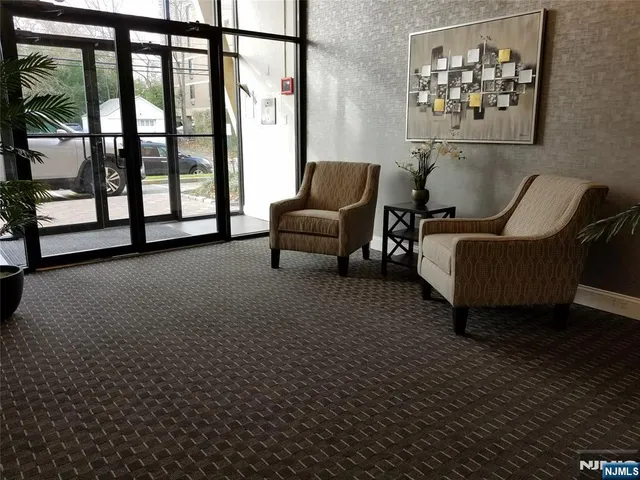 a living room with furniture and a floor to ceiling window