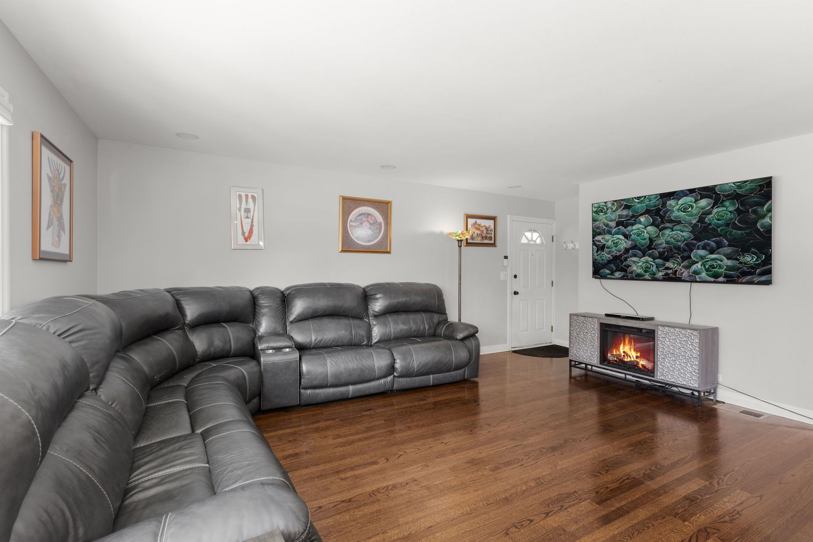 1013 Longaker Road Northbrook, IL 60062 - Photo 2 of 30 a living room with furniture a flat screen tv and a fireplace